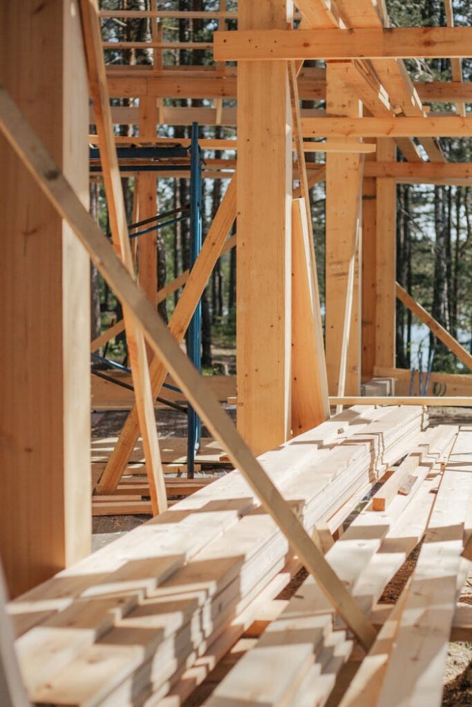Sunlit construction site with wooden lumber arranged in rows. Perfect for building projects.